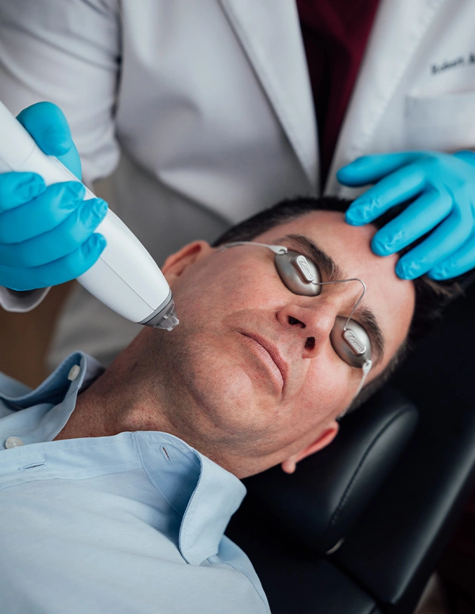 Medical professional administering nasal COVID-19 test to male patient in clinical setting