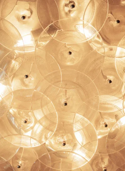 Abstract coffee-stained paper texture with overlapping circular watermarks and droplet marks in warm sepia tones