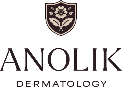 Anolik Dermatology logo featuring a shield with floral emblem above the practice name in serif font