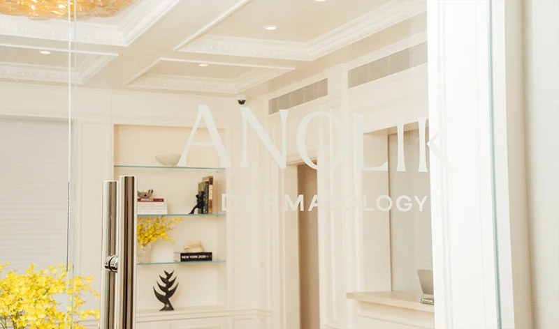 Modern white interior office space with glass partitions, wooden accents, and minimalist decor